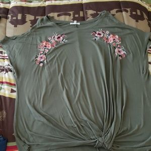 Olive green top with floral accents.